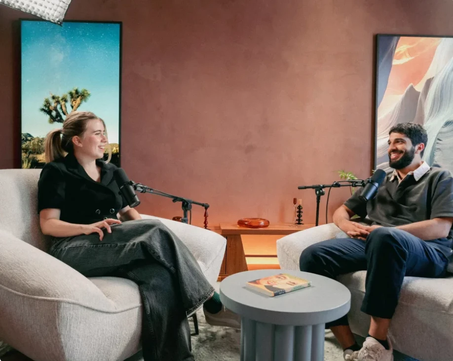 The same set in session, with two people in the armchairs mid-conversation